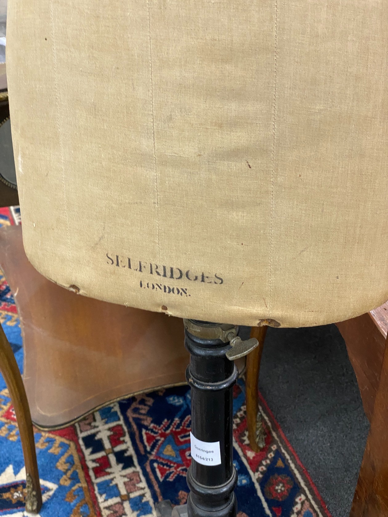 Selfridges, London. An early 20th century tailor’s dummy, on telescopic tripod ebonised stand